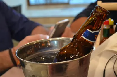 a bottle of beer in a metal bucket at Da Puccio Rawai Guesthouse in Rawai Beach