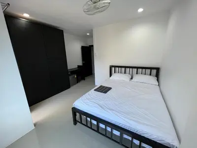 a bedroom with a bed and a black closet at Patong Easy life 5 in Patong Beach
