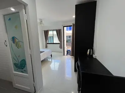a room with a bedroom with a bed and a mirror at Patong Easy life 5 in Patong Beach