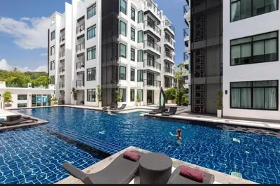 a swimming pool in front of two tall buildings at Modern 2-Bedroom Condo in Kamala Near the beach in Kamala Beach