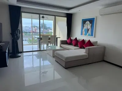 a living room with a couch and red pillows at Modern 2-Bedroom Condo in Kamala Near the beach in Kamala Beach