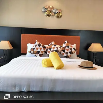 a bedroom with a bed with two hats and pillows at Modern 2-Bedroom Condo in Kamala Near the beach in Kamala Beach