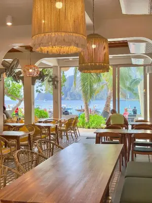 a restaurant with tables and chairs and a view of the ocean at Phi Phi at Pier in Phi Phi Don