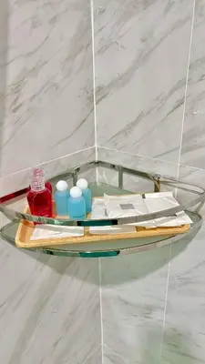 a glass shelf on a wall with items on it at The Saii in Ko Yao Yai