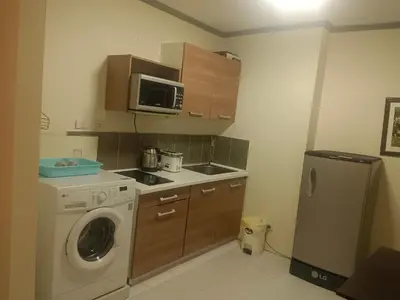 a kitchen with a washing machine and a microwave at Patong tower mountain view m705 in Patong Beach