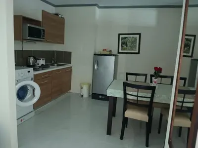 a kitchen with a table and a washing machine at Patong tower mountain view m705 in Patong Beach