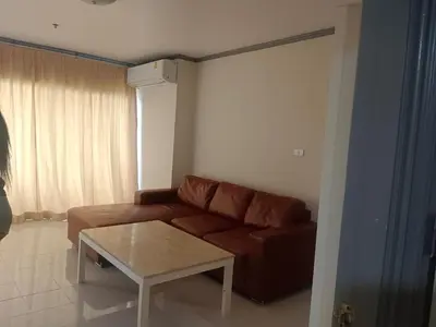 a living room with a brown couch and a coffee table at Patong tower mountain view m705 in Patong Beach