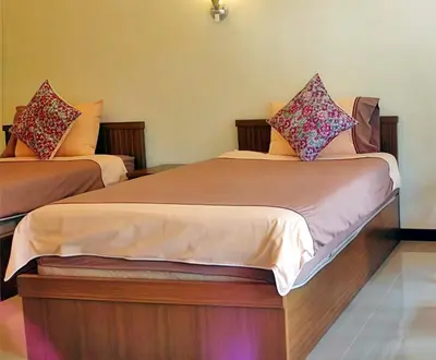 two beds in a hotel room with at OYA International Resort Phuket \u666e\u5409\u5c9b\u6b27\u96c5\u56fd\u9645\u5ea6\u5047\u9152\u5e97 in Phuket Town