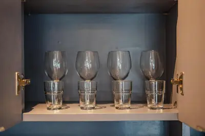 a row of wine glasses sitting on a shelf at C161 1Km to beach New City gate in Kamala Beach