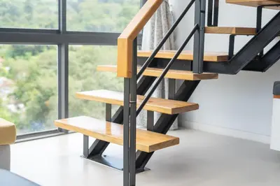 a wooden staircase in a room with a window at 650m to beach condofast WiFi in Kamala Beach