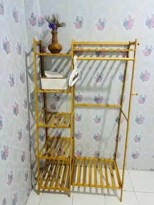 a yellow shelf next to a wall at Navy Guesthouse in Ban Laem Sai