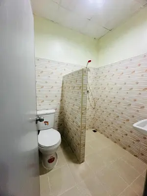 a bathroom with a toilet and a sink at Navy Guesthouse in Ban Laem Sai
