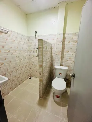 a bathroom with a toilet and a sink at Navy Guesthouse in Ban Laem Sai