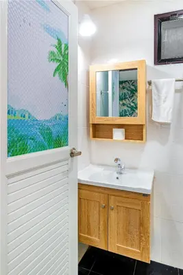 a bathroom with a sink and a mirror at Songbird Suites - Deluxe Twin Suite and Scooter in Ao Nang Beach