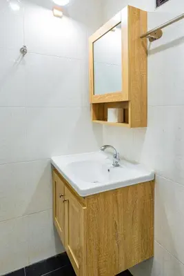 a bathroom with a sink and a mirror at Songbird Suites - Deluxe Twin Suite and Scooter in Ao Nang Beach