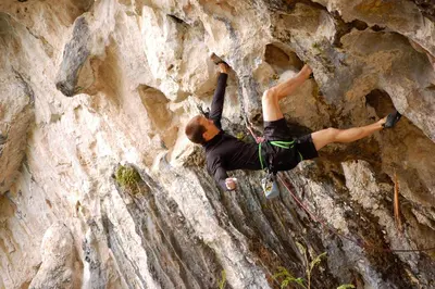 a woman is climbing on a rock wall at Songbird Suites - Deluxe Twin Suite and Scooter in Ao Nang Beach