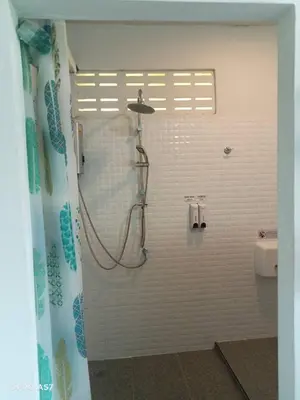 a shower in a bathroom with a shower curtain at Koh Yao Yai Resort Ta & Yai ที่พักเกาะยาวใหญ่ตากับยายรีสอร์ท in Ban Lo Pa Ret