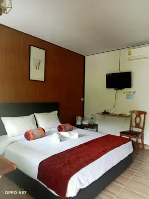 a large bed in a hotel room with a television at Koh Yao Yai Resort Ta & Yai ที่พักเกาะยาวใหญ่ตากับยายรีสอร์ท in Ban Lo Pa Ret