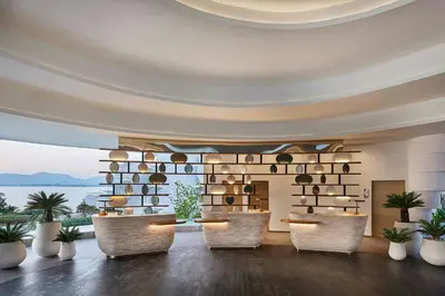 a lobby with chairs and a wall of wine bottles at Veranda Resort Phuket, Autograph Collection in Panwa Beach
