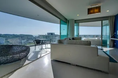 a living room with a couch and a table at Veloche Apartment by Continent in Karon Beach