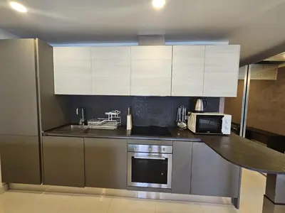 a kitchen with stainless steel appliances and white cabinets at C162 Sea View 8 Minuets to Patong Karon Butter Fly in Karon Beach