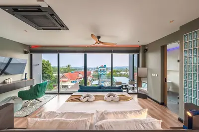 a bedroom with a large bed and a large window at V160 Beautiful Sea View Full Smart House 3BR in Rawai Beach