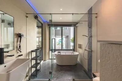 a bathroom with a bath tub and a glass wall at V160 Beautiful Sea View Full Smart House 3BR in Rawai Beach