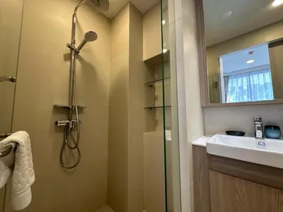 a bathroom with a shower and a sink at 2 BD Skypark Condo with Terrace in Laguna Phuket