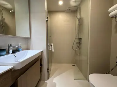 a bathroom with a sink and a shower at 2 BD Skypark Condo with Terrace in Laguna Phuket