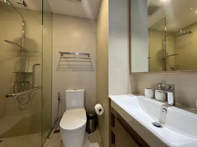 a bathroom with a toilet and a sink and a shower at 1 BD Laguna Skypark Golf Course View in Phuket