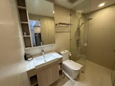 a bathroom with a toilet and a sink and a shower at 2 BD Skypark Condo in Laguna Phuket