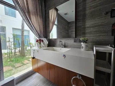 a bathroom with a sink and a large window at Angsana Beachfront Residences in Phuket