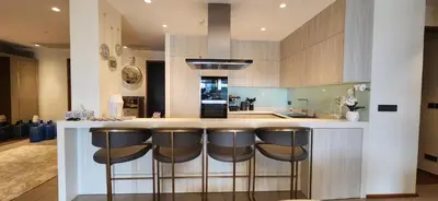 a kitchen with a counter with bar stools at Angsana Beachfront Residences in Phuket