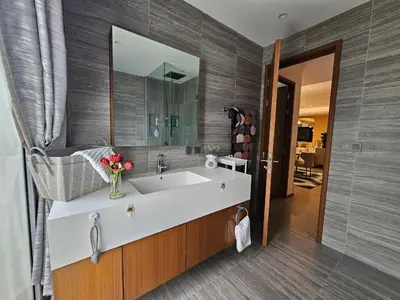 a bathroom with a white sink and a mirror at Angsana Beachfront Residences in Phuket
