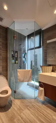 a bathroom with a shower and a toilet and a sink at Angsana Beachfront Residences in Phuket