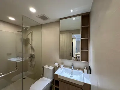 a bathroom with a toilet and a sink and a shower at 2 BD Laguna Skypark Condo in Phuket