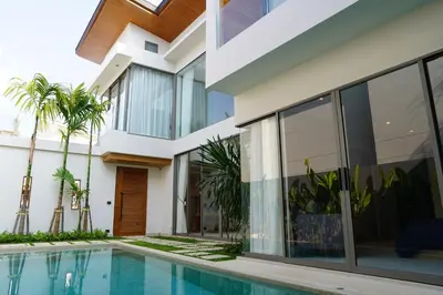 a house with a swimming pool in front of it at Zenithy Villas 3BD in Phuket