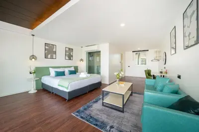a bedroom with a bed and a couch in a room at Patong Cliff Villa Phuket 12 bedroom in Patong Beach