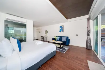 a bedroom with a large white bed and a desk at Patong Cliff Villa Phuket 12 bedroom in Patong Beach