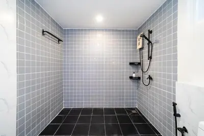 a bathroom with a shower with blue tiles at Patong Cliff Villa Phuket 12 bedroom in Patong Beach