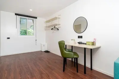 a white room with a desk and a green chair at Patong Cliff Villa Phuket 12 bedroom in Patong Beach