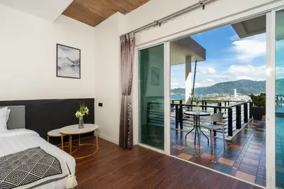 a bedroom with a bed and a balcony with a view at Patong Cliff Villa Phuket 12 bedroom in Patong Beach