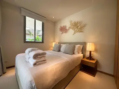 a bedroom with a bed with towels on it at Trichada Sky 3BD in Phuket