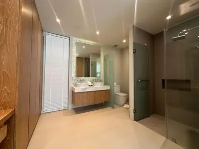 a bathroom with a sink and a toilet and a mirror at Trichada Sky 3BD in Phuket