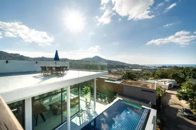 a view from the balcony of a house with a swimming pool at Amor Primero - sea view pool villa with maid in Kamala Beach