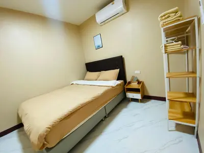 a small bedroom with a bed and a book shelf at Coral Retreat Koh Yao Yai in Ko Thanan
