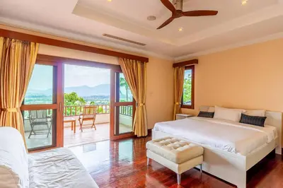a bedroom with a large bed and a balcony at Luxurious Phuket Escape - Lakewood Hills in Layan Beach