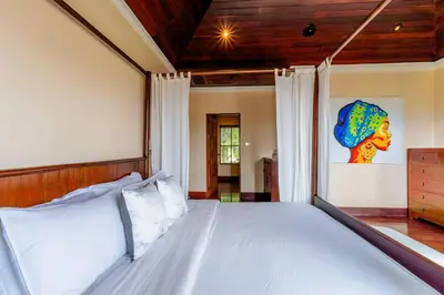 a bedroom with a large bed with a wooden headboard at Luxurious Phuket Escape - Lakewood Hills in Layan Beach