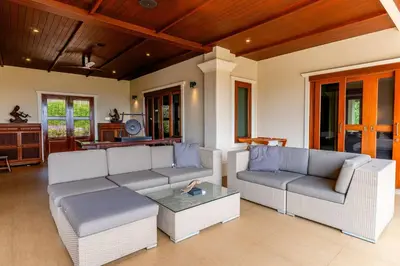 a living room with two couches and a table at Luxurious Phuket Escape - Lakewood Hills in Layan Beach