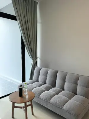 a living room with a couch and a table at 150 square meters 3BR with parking townhouse near golf course, UWC school, Nayang Beach, airport in Ban Muang Mai (1)